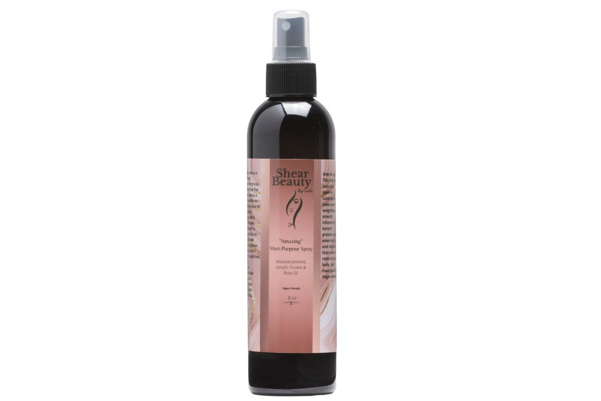 "Amazing" Multi-Purpose Spray is in a sleek black bottle, offering multiple benefits to all hair types, standing in a all white background.